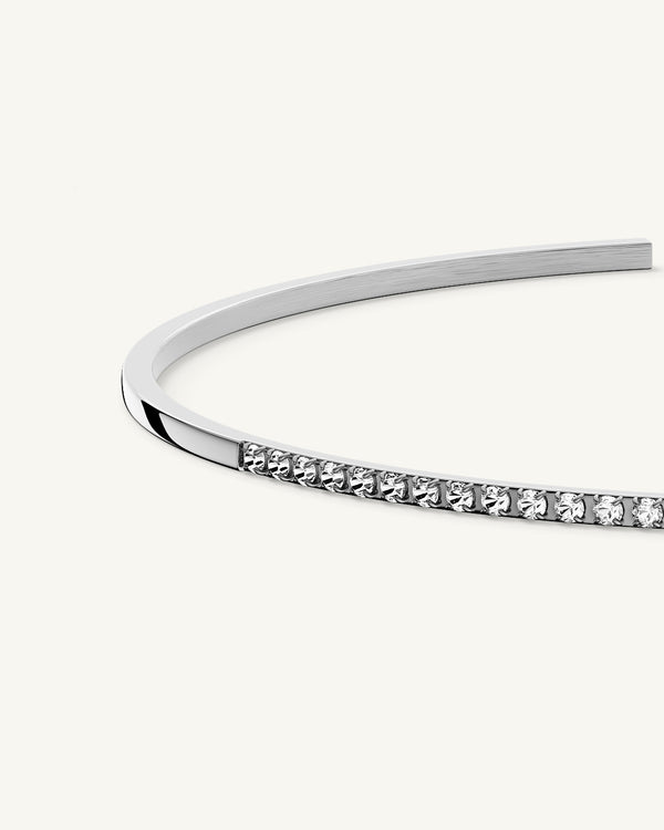 A Bangle in Rhodium-plated 316L stainless steel from Waldor & Co. One size. The model is Bliss Bangle Polished.