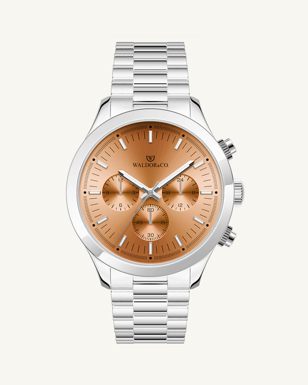 A round mens watch in rhodium-plated silver from Waldor & Co. with orange sunray dial and a second hand. Seiko movement. The model is Chrono 44 Como 44mm.