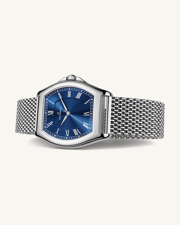 A tonneau mens watch in rhodium-plated silver from Waldor & Co. with blue sunray dial and a second hand. Seiko movement. The model is Constant 40 Lecco.