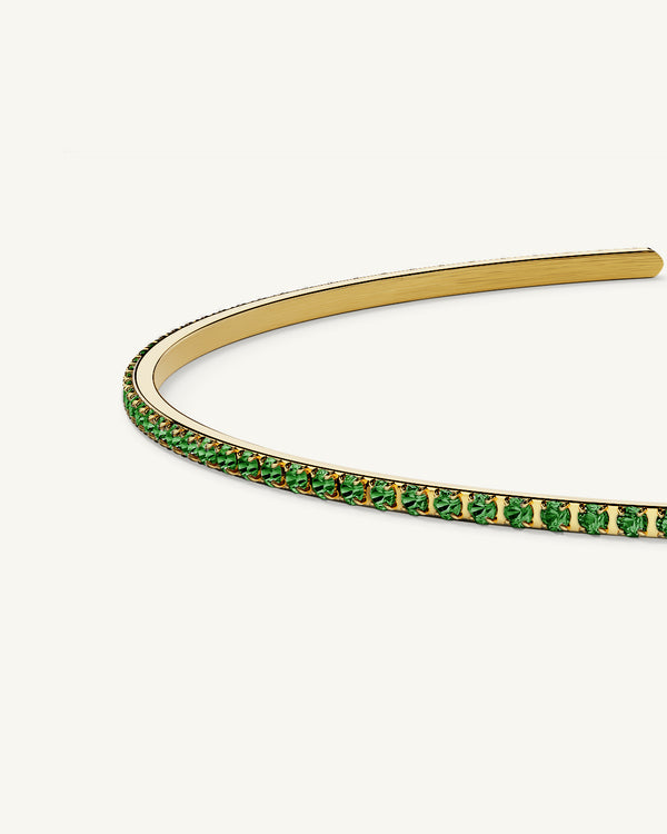 A Bangle in 14k gold-plated 316L stainless steel with green stones from Waldor & Co. One size. The model is Dulcet Bangle Polished.