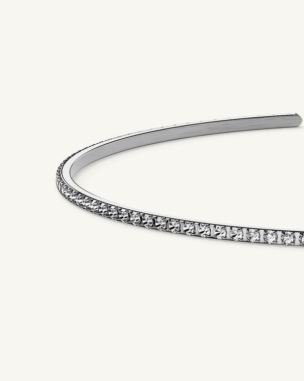 A Bangle in Rhodium-plated 316L stainless steel from Waldor & Co. One size. The model is Dulcet Bangle Polished.