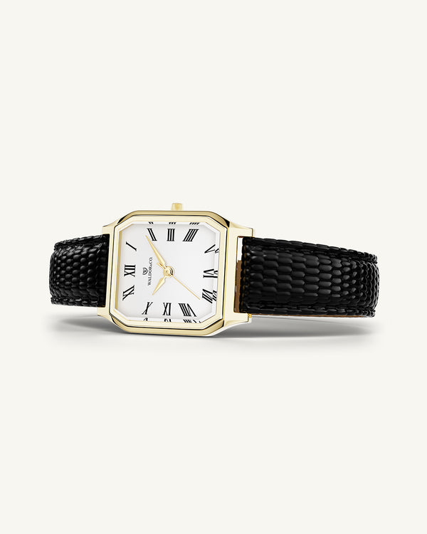 A square womens watch in 22k gold from Waldor & Co. with white Diamond Cut Sapphire Crystal glass dial. Strap in black Genuine leather. Seiko movement. The model is Eternal 22 Varenna. 