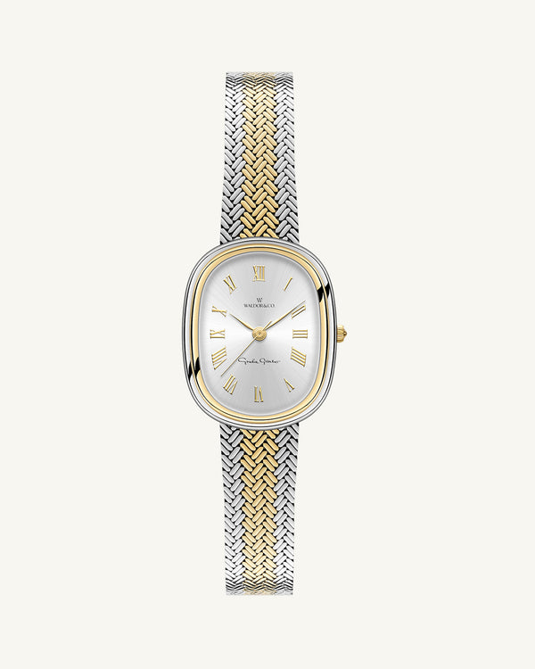 An oval womens watch created under exclusive license from the Greta Garbo™ estate. Featuring a silver sunray dial with gold Roman numerals, framed in a dual-tone case. Seiko movement.