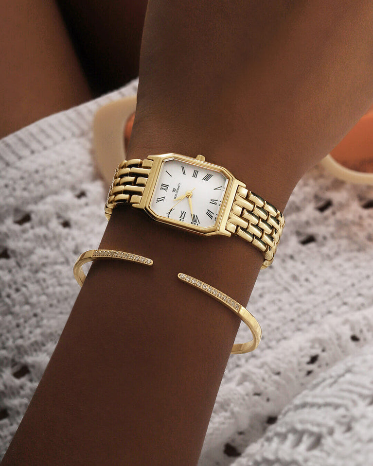 A square womens watch in 22k gold from Waldor & Co. with white Diamond Cut Sapphire Crystal glass dial. Seiko movement. The model is Eternal 22 Bellagio.