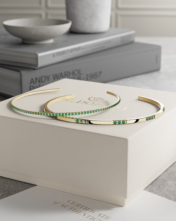  A Bangle in 14k gold-plated 316L stainless steel with green stones from Waldor & Co. One size. The model is Dulcet Bangle Polished.