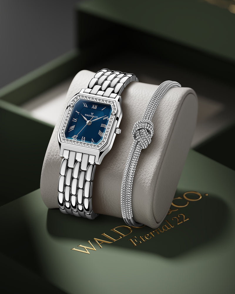 A square womens watch in Rhodium-plated 316L stainless steel from Waldor & Co. with dark blue dial. Bezel with premium crystals. Diamond Cut Sapphire Crystal glass dial. Seiko movement. The model is Eternal 22 Bellagio Pavè.