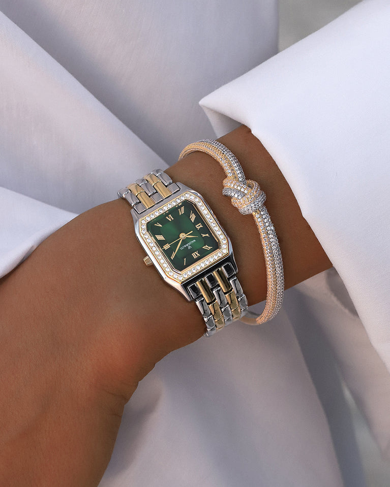  A square womens watch in Rhodium-plated 316L stainless steel from Waldor & Co. with emerald green dial. Bezel with premium crystals. Diamond Cut Sapphire Crystal glass dial. Seiko movement. The model is Eternal 22 Bellagio Pavè.