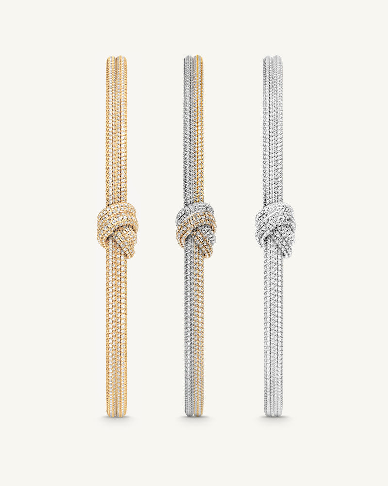 Three bangles in 14k-gold and silver plated copper from Waldor & Co. One size. The model is Dual Knot Bangle Pavè.