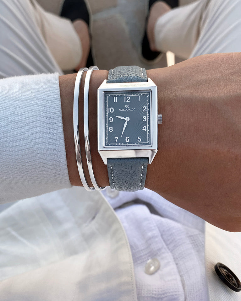  A square mens watch in Rhodium-plated 316L stainless steel from Waldor & Co. with grey guilloche dial. Miyota movement. Leather strap. The model is Conceptual 37 Cap Ferrat.