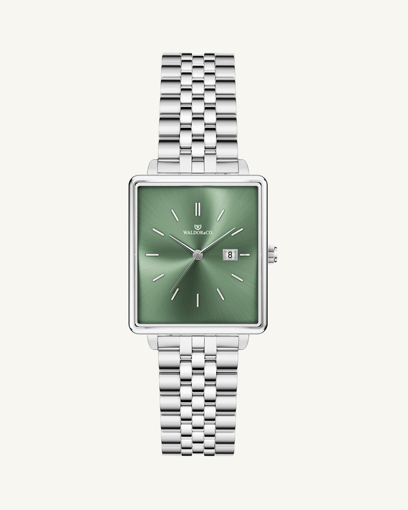 A square womens watch in silver from WALDOR & CO. with green sunray dial and a second hand. The model is Delight 32 Chelsea 28x32mm. 