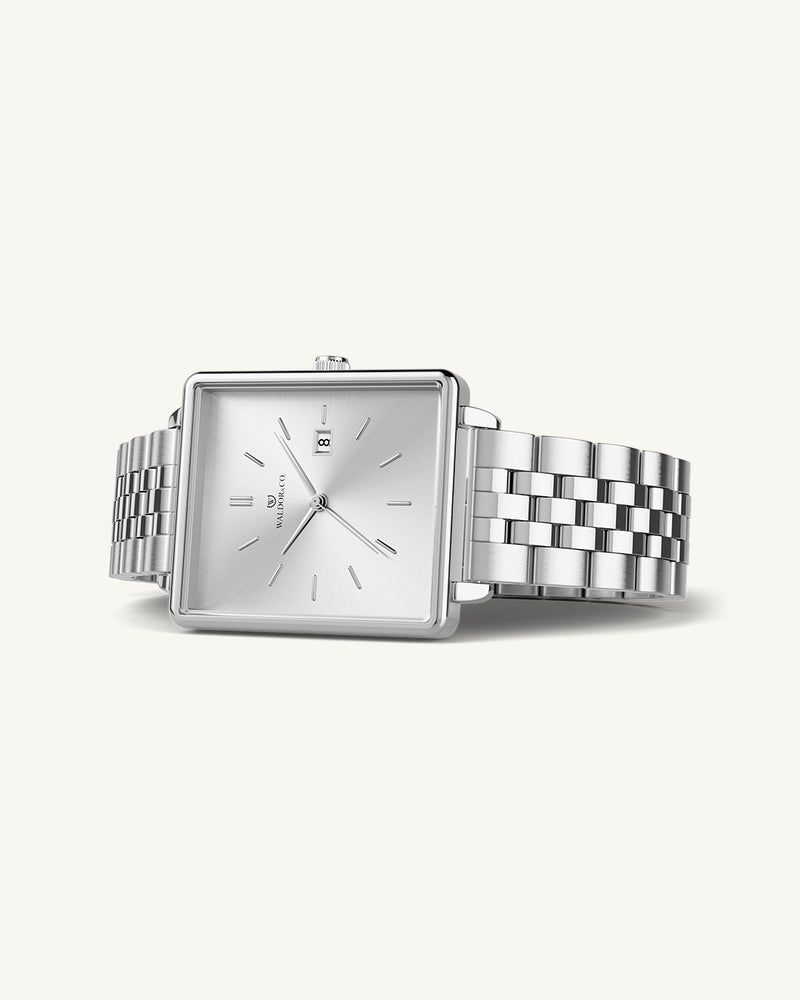 A square womens watch in silver from WALDOR & CO. with blue sunray dial and a second hand. The model is Delight 32 Chelsea 28x32mm. 