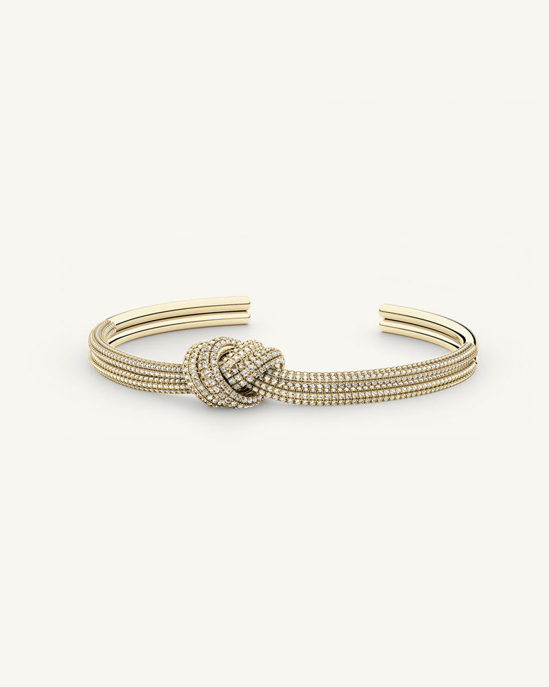 A Bangle in 14k-gold plated copper from Waldor & Co. One size. The model is Dual Knot Bangle Pavè.