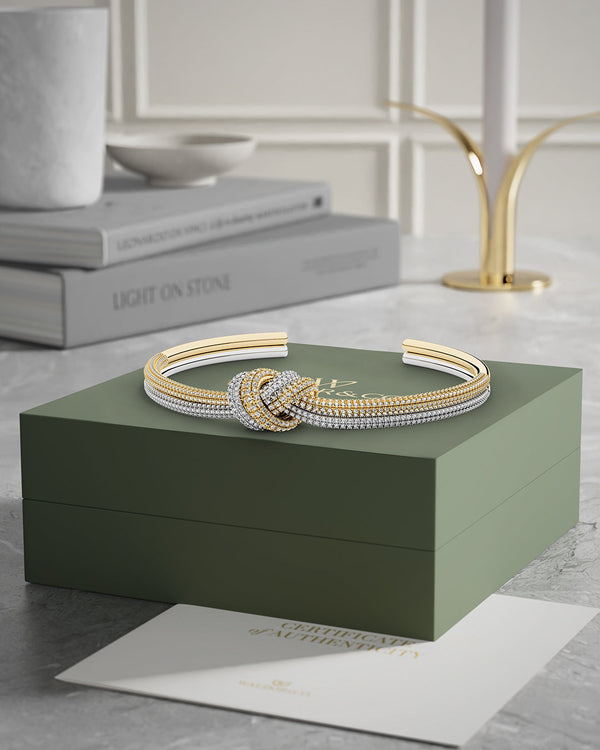 A Bangle in 14k-gold plated and silver polished copper from Waldor & Co. One size. The model is Dual Knot Bangle Pavè.