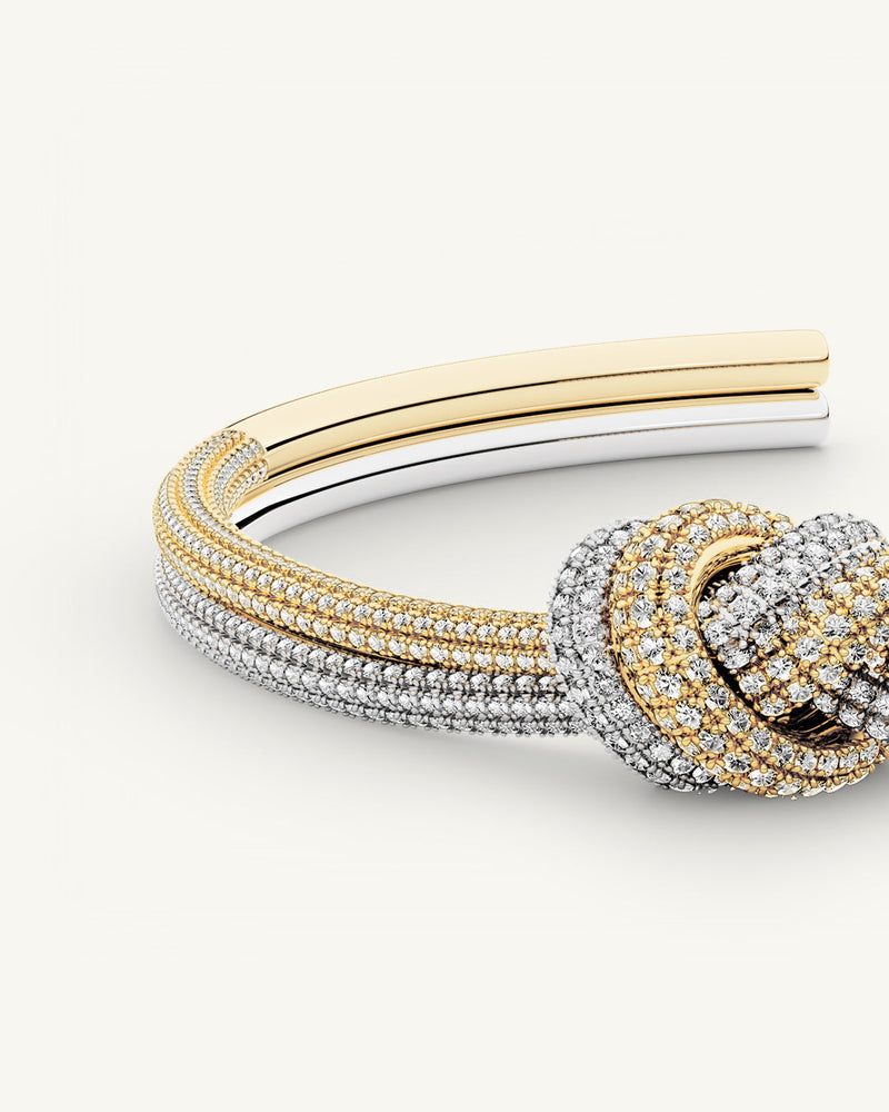 A Bangle in 14k-gold plated and silver polished copper from Waldor & Co. One size. The model is Dual Knot Bangle Pavè.