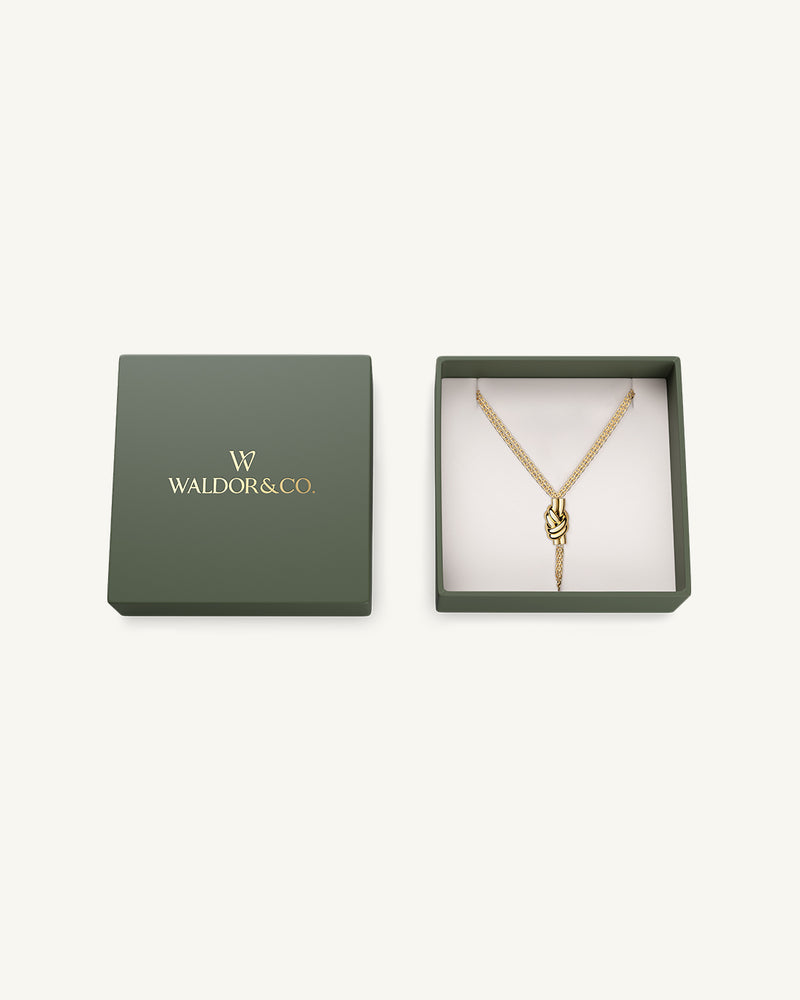 Necklace in gold plated-316L stainless steel from Waldor & Co. The model is Dual Knot Necklace Polished.
