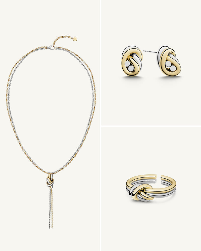 A polished stainless steel jewelry set in 14k gold from Waldor & Co. One size. The model is Dual Knot Ring.