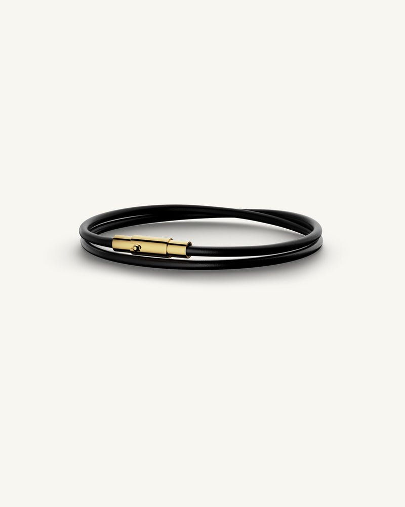 A Leather Bracelet in 14k gold-plated 316L stainless steel from Waldor & Co. The model is Dual Leather Bracelet Polished.