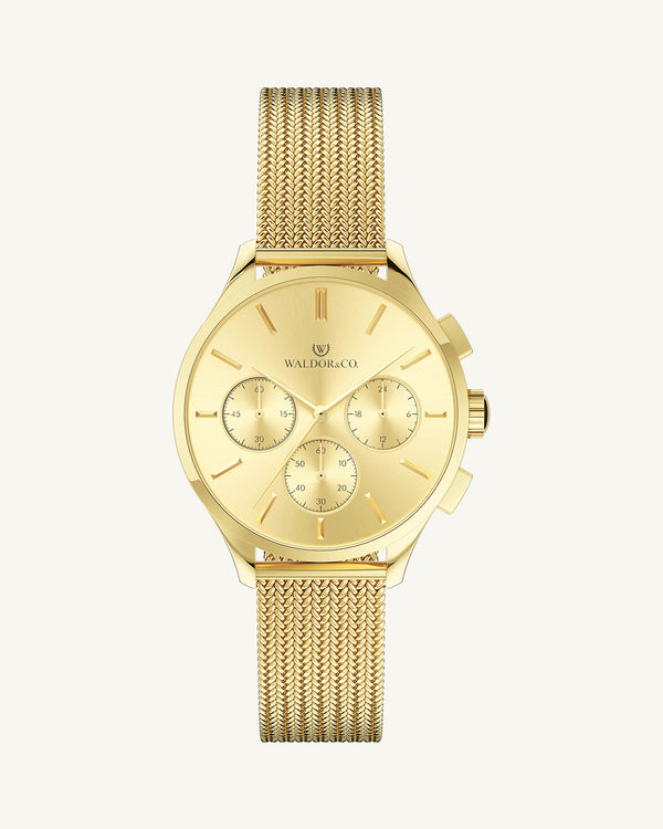 A round womens watch in 14k gold-plated 316L stainless steel from Waldor & Co. with gold dial and a second hand. Seiko movement. The model is Epoch 36 Formentera 36mm.