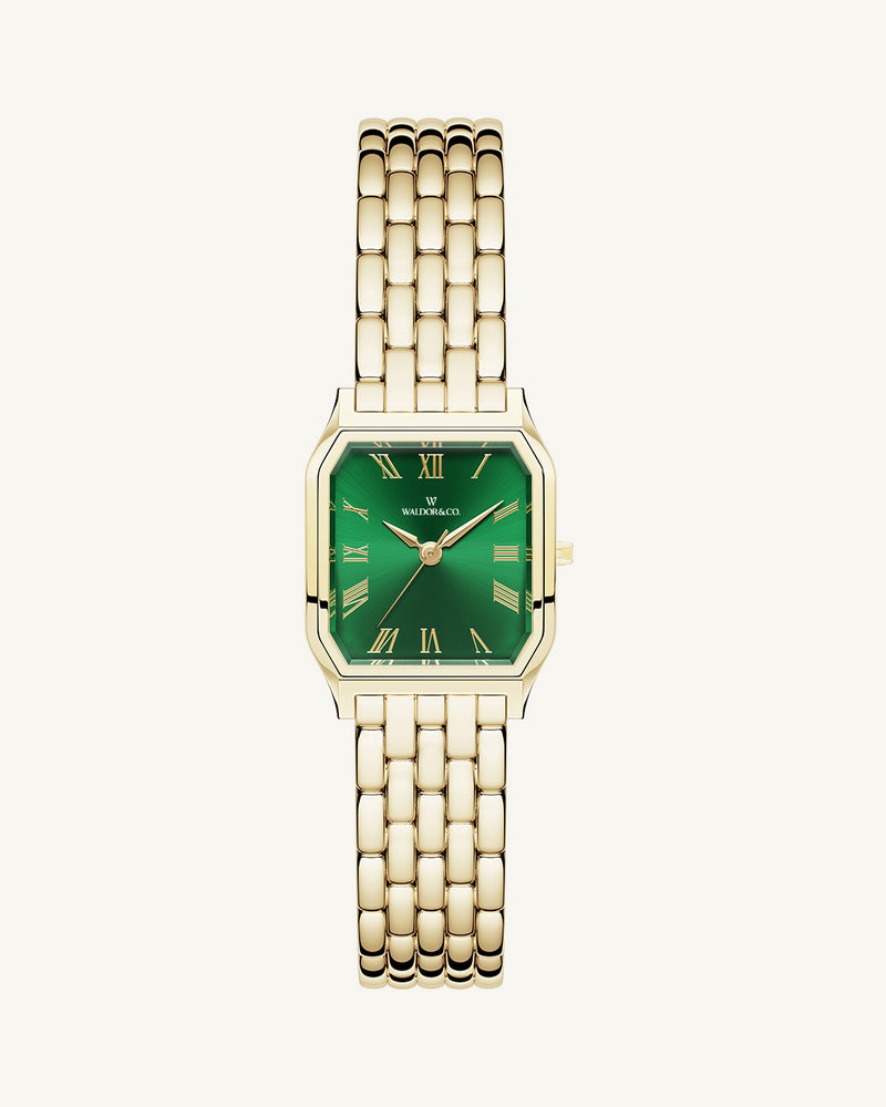 A square womens watch in 22k gold from Waldor & Co. with green Diamond Cut Sapphire Crystal glass dial. Seiko movement. The model is Eternal 22 Bellagio.