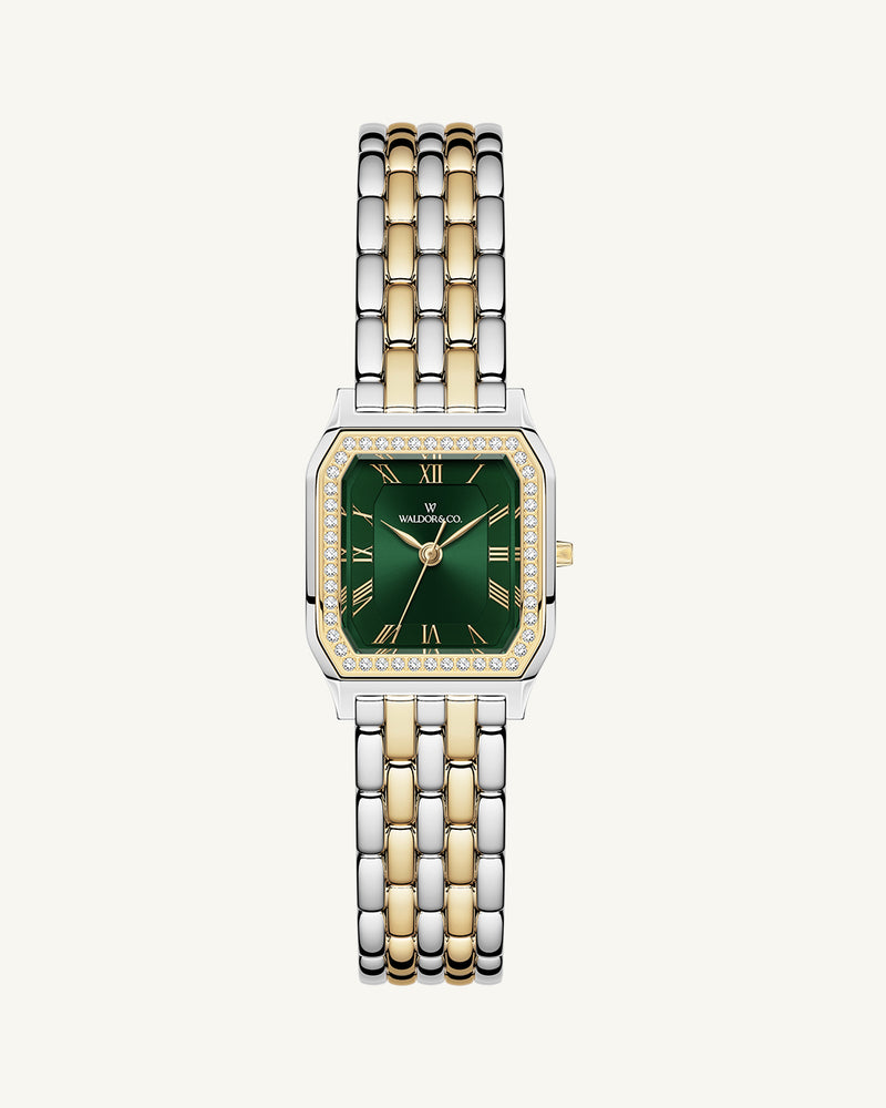 A square womens watch in Rhodium-plated 316L stainless steel from Waldor & Co. with emerald green dial. Bezel with premium crystals. Diamond Cut Sapphire Crystal glass dial. Seiko movement. The model is Eternal 22 Bellagio Pavè.