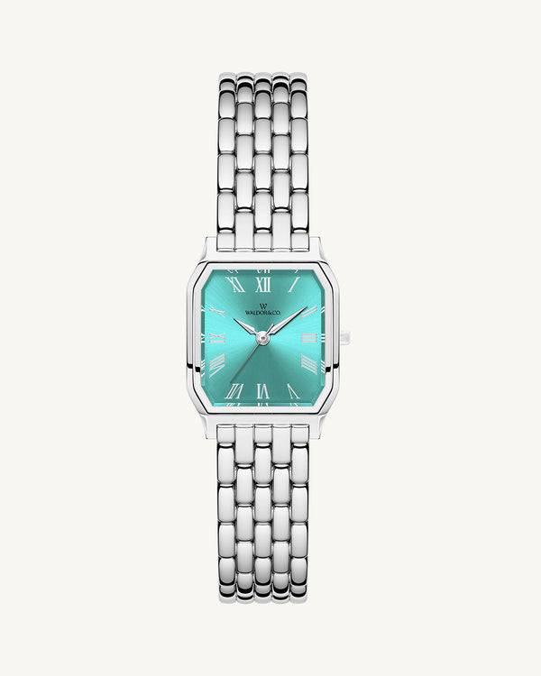 A square womens watch in Rhodium-plated 316L stainless steel from Waldor & Co. with turquoise Diamond Cut Sapphire Crystal glass dial. Seiko movement. The model is Eternal 22 Bellagio.