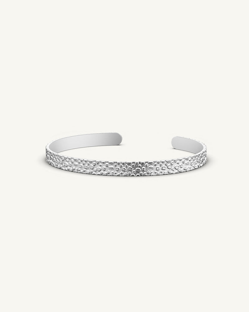 A polished stainless steel bangle in silver from Waldor & Co. One size. The model is Frost Bangle Polished.