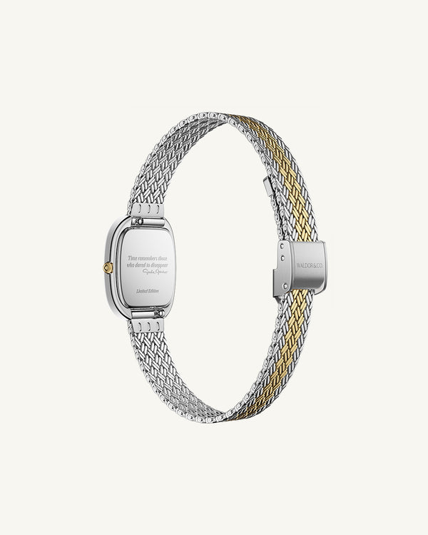 An oval womens watch created under exclusive license from the Greta Garbo™ estate. Featuring a silver sunray dial with gold Roman numerals, framed in a dual-tone case. Seiko movement. 