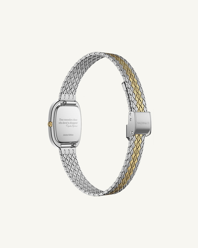 An oval womens watch created under exclusive license from the Greta Garbo™ estate. Featuring a silver sunray dial with gold Roman numerals, framed in a dual-tone case. Seiko movement. 