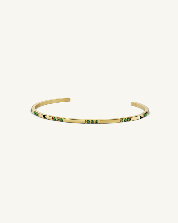 A Bangle in 14k gold-plated 316L stainless steel with green stones from Waldor & Co. One size. The model is Opulent Bangle Polished.