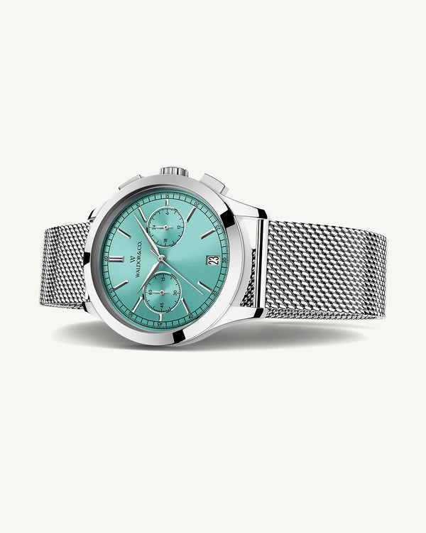 A round mens watch in rhodium-plated silver from Waldor & Co. with turquoise sunray dial and a second hand. Seiko movement. The model is Chrono 39 Sardinia 39mm.