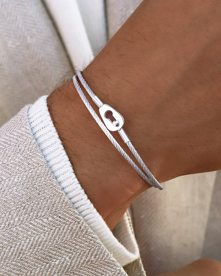  A polished stainless steel bangle in silver from Waldor & Co. One size. The model is Como Bangle Dual Polished