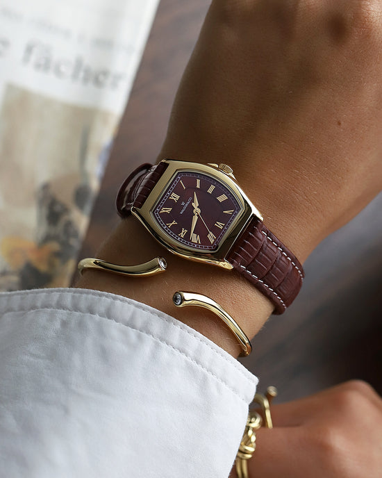 lifestyle_image, A square womens watch in 22k gold plated 316L stainless steel from Waldor & Co. with domed mineral glass dial. Seiko movement. The model is Constant 36 Laglio.