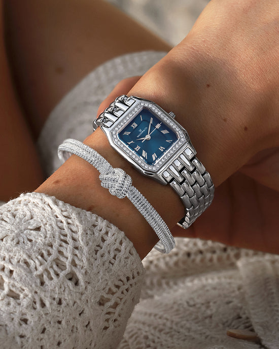 lifestyle_image, A square womens watch in Rhodium-plated 316L stainless steel from Waldor & Co. with dark blue dial. Bezel with premium crystals. Diamond Cut Sapphire Crystal glass dial. Seiko movement. The model is Eternal 22 Bellagio Pavè.