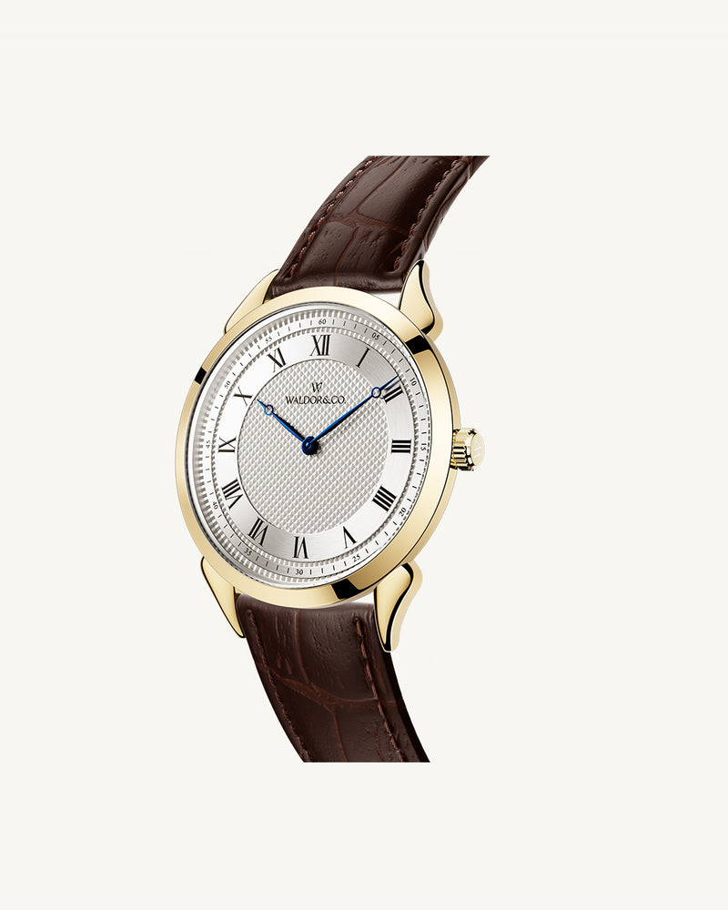A round watch in gold from Waldor & Co. with white sunray patterned dial. Ronda movement. The model is Original 40 Côte d'Azur 40mm.