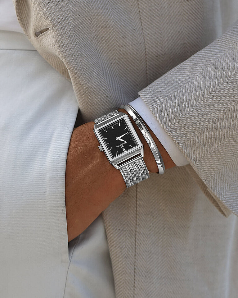  A square mens watch in rhodium-plated silver from Waldor & Co. with black sunray dial. Seiko movement. The model is Conceptual 37 Antibes 29x43mm.